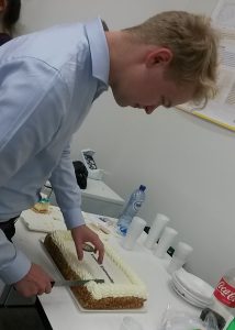 Treasurer Mark cutting the cake.